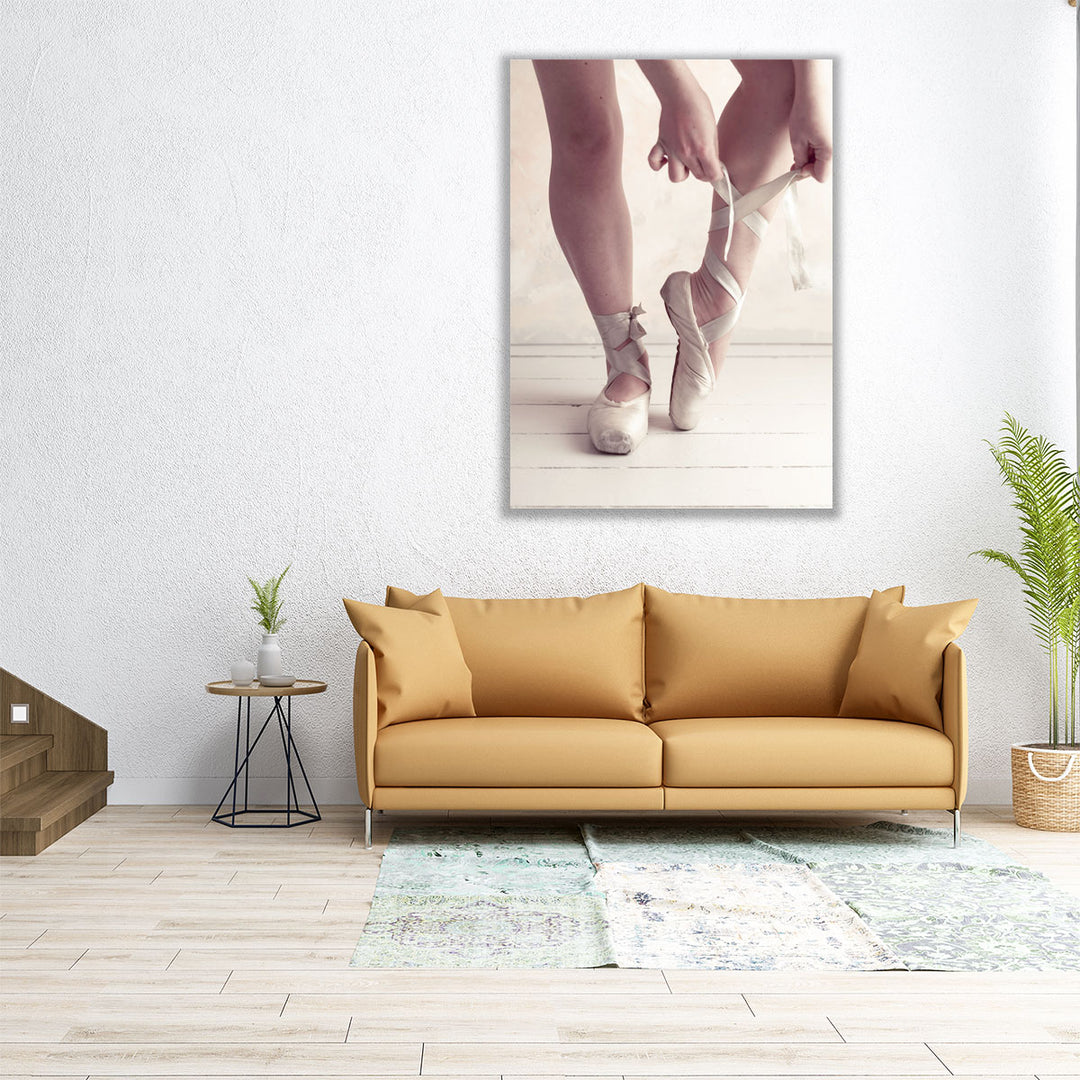 Close-up Of A Ballerina Putting On Ballet Slippers - Canvas Print Wall Art