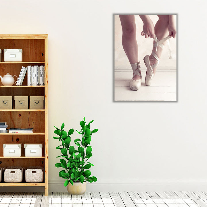 Close-up Of A Ballerina Putting On Ballet Slippers - Canvas Print Wall Art