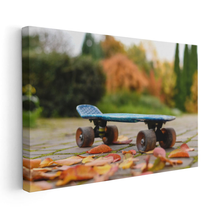 Close Up of a Skateboard With Colorful Autumn Leaves - Canvas Print Wall Art