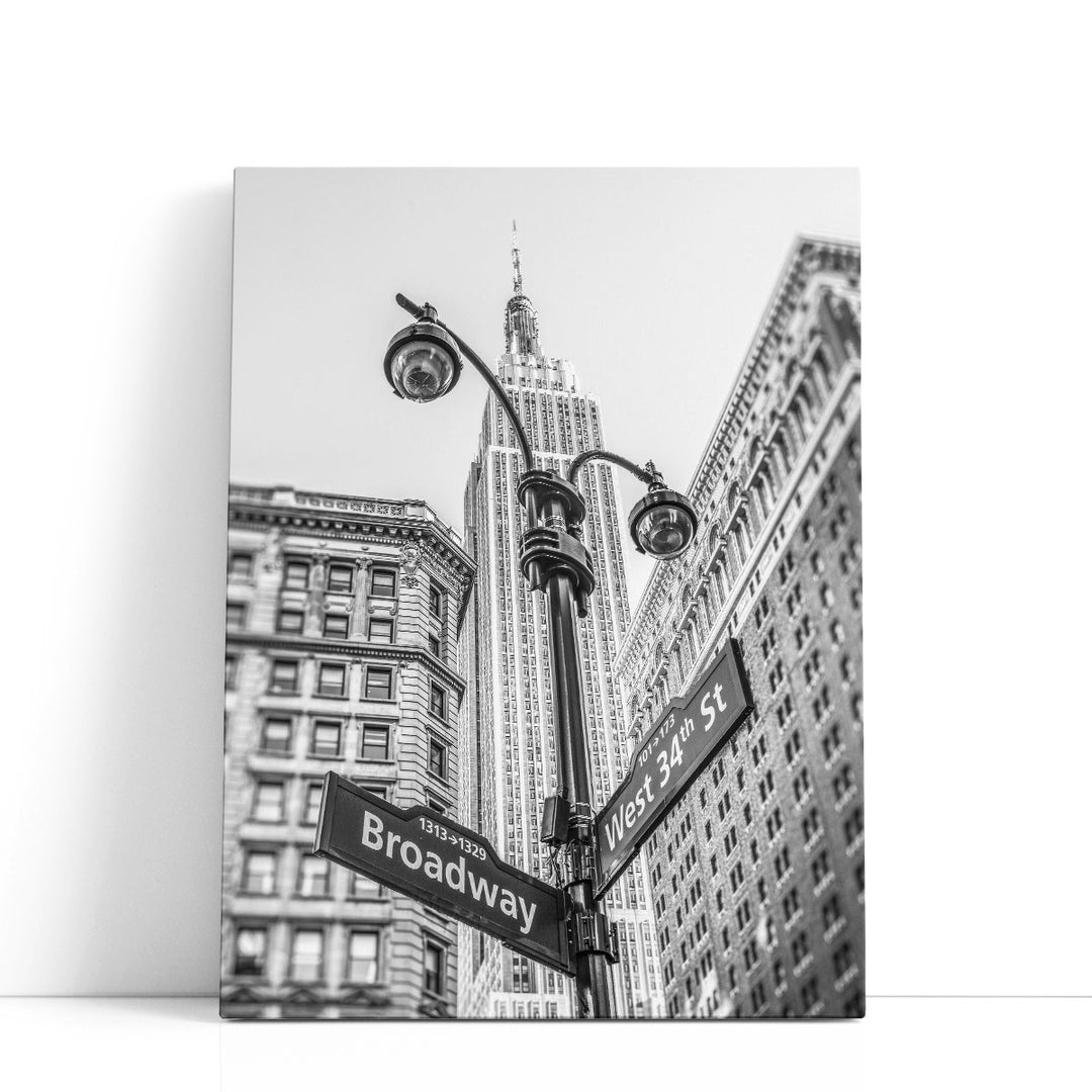 Street Lamp And Signs With Empire State Building, New York 2 Black And White - Canvas Print Wall Art