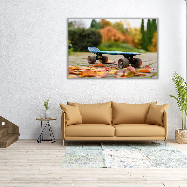 Close Up of a Skateboard With Colorful Autumn Leaves - Canvas Print Wall Art