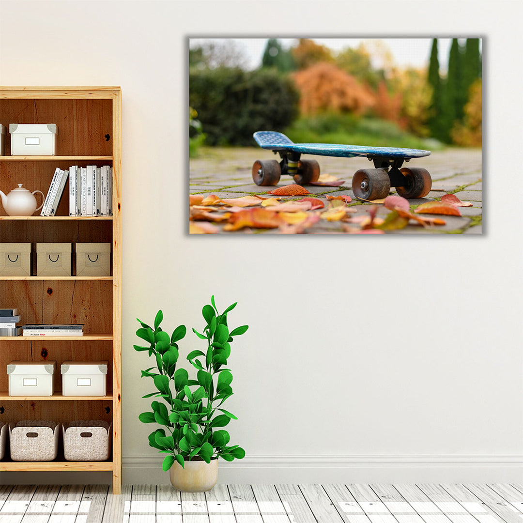 Close Up of a Skateboard With Colorful Autumn Leaves - Canvas Print Wall Art